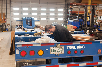 technician repairing a semi trailer frame